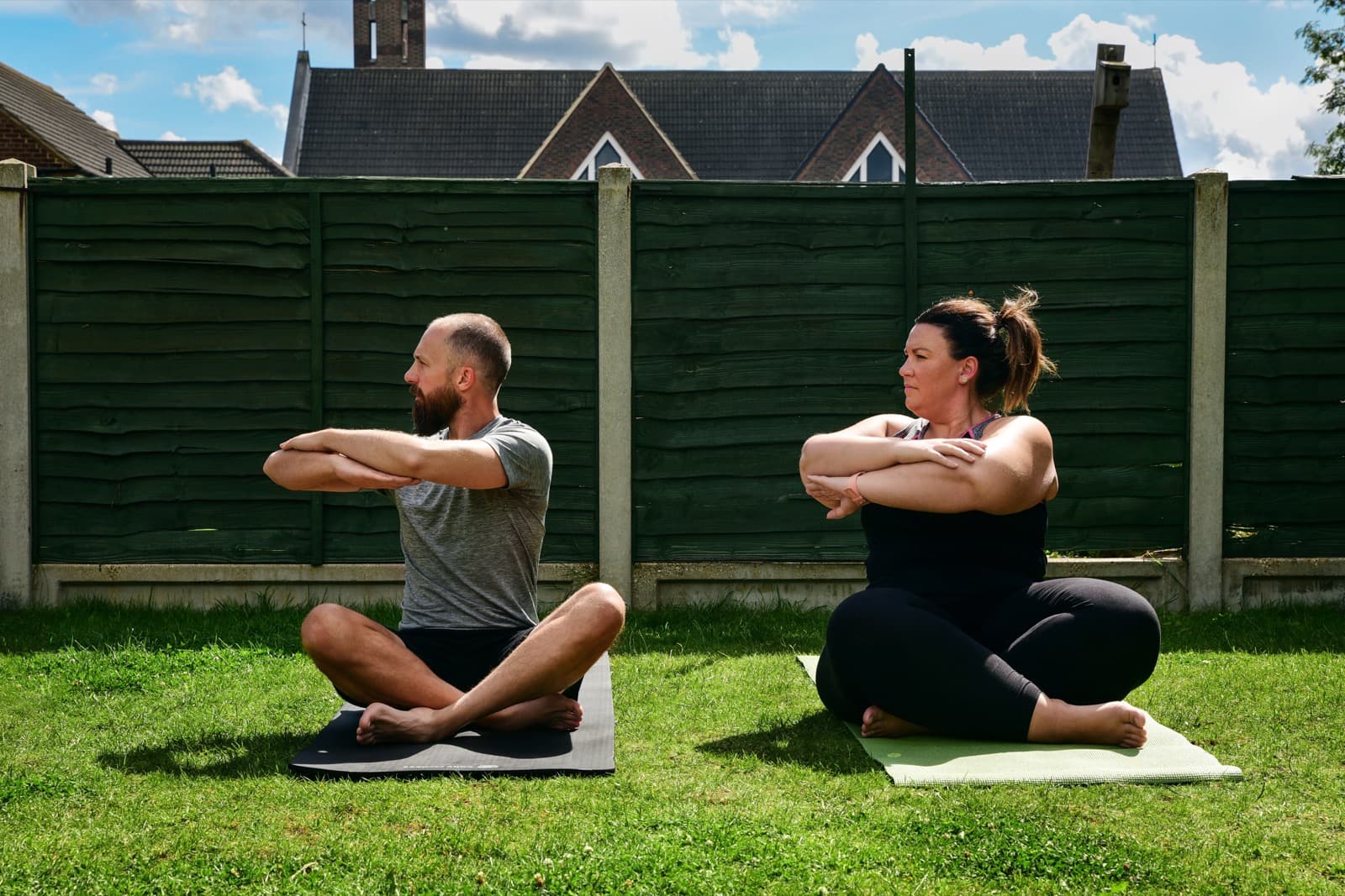 In a class in Cranham, two members mid spinal twist