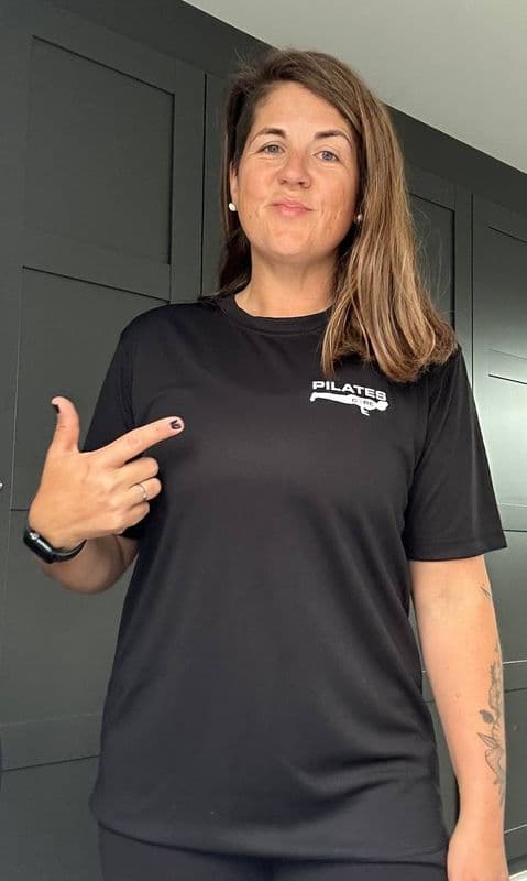 Kim Karlsson, founder of PilatesCOREuk, in a branded Pilates CORE tee